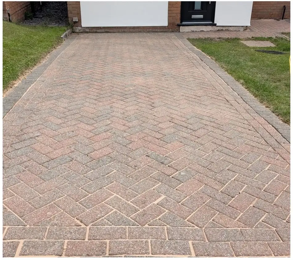 Clean herringbone block paved driveway after pressure washing