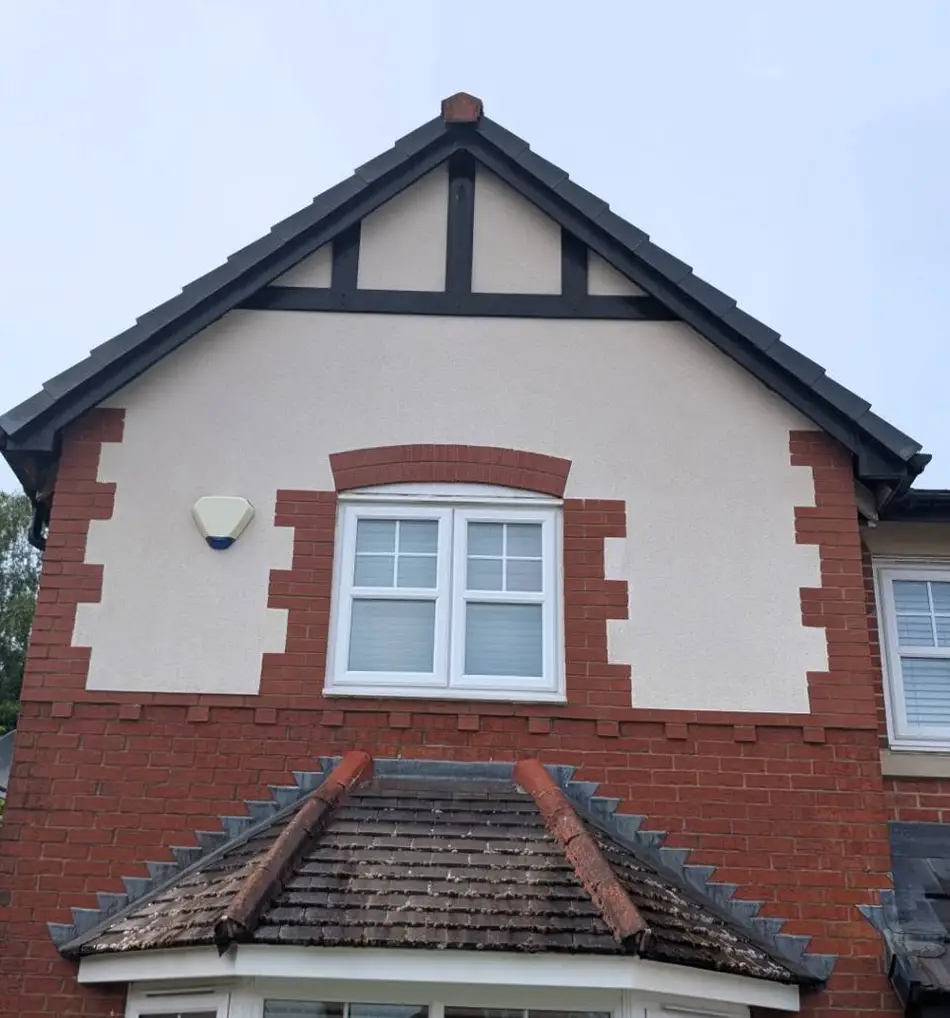 Clean white rendered gable wall after softwash treatment
